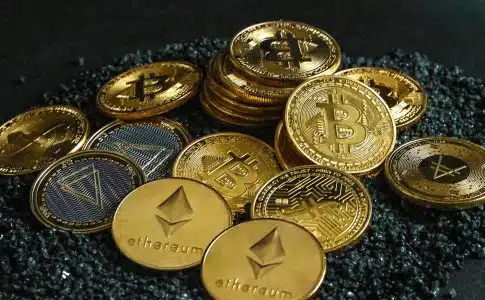 a pile of bitcoins sitting on top of a pile of gravel