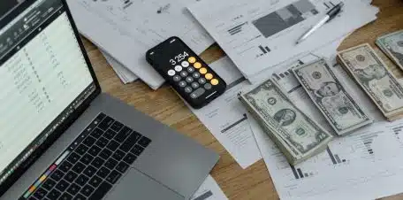 Banknotes and Calculator on Table