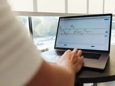 person using MacBook Pro on table