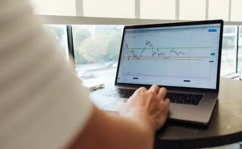 person using MacBook Pro on table